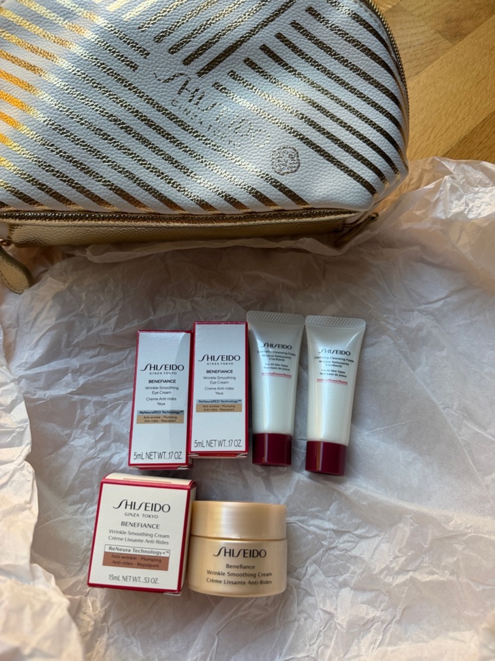Shiseido skincare set with white and gold striped pouch